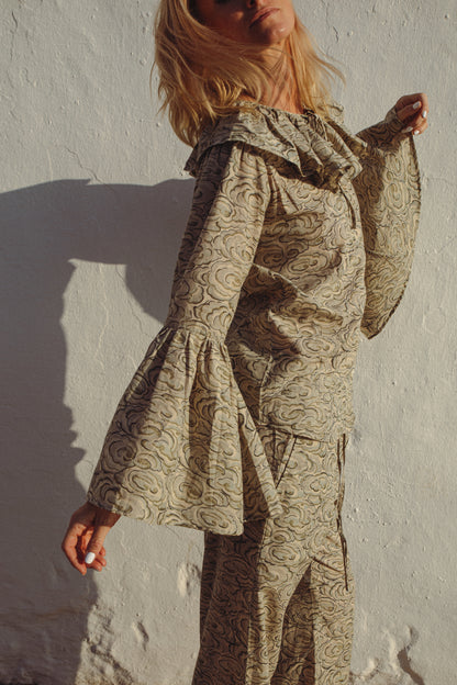 Person wearing kumo cloud print  pj set against a plain background