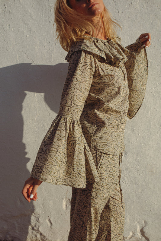 Person wearing kumo cloud print  pj set against a plain background